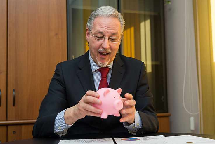 businessman-holding-piggy-bank
